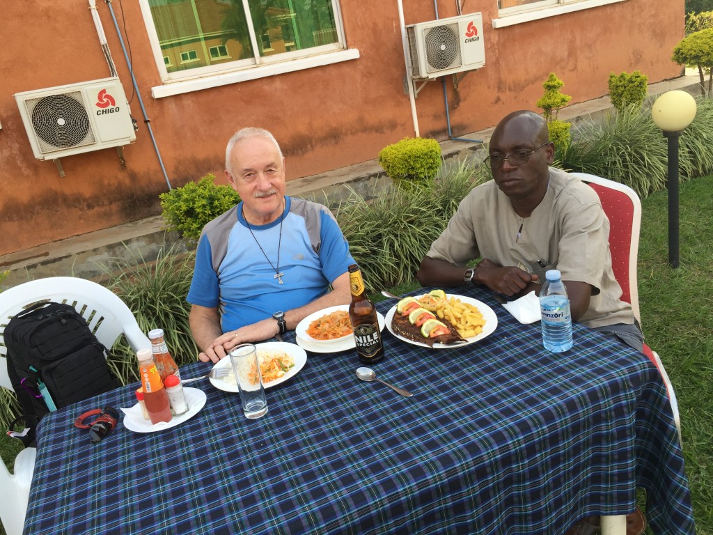 An exhausted Deacon and friend Bob Okello sharing a snack at Churchill downs in Gulu.