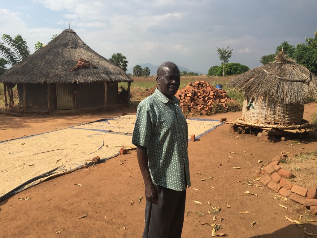 My very good friend Francis Onek with drying sesame seeds, a small storage hut for ground nuts and a larger storage hut for different grains. 