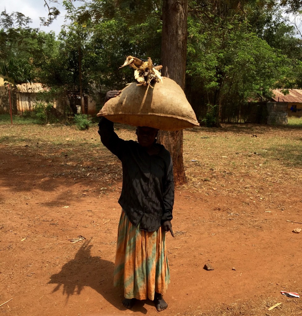 I wonder how many pounds this older woman has carried on her head in her lifetime?