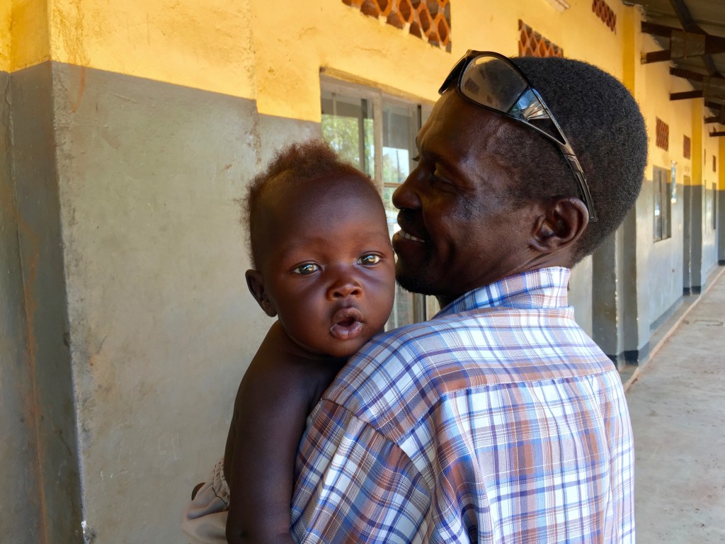 A father took time off from the field work to visit his sick child. 