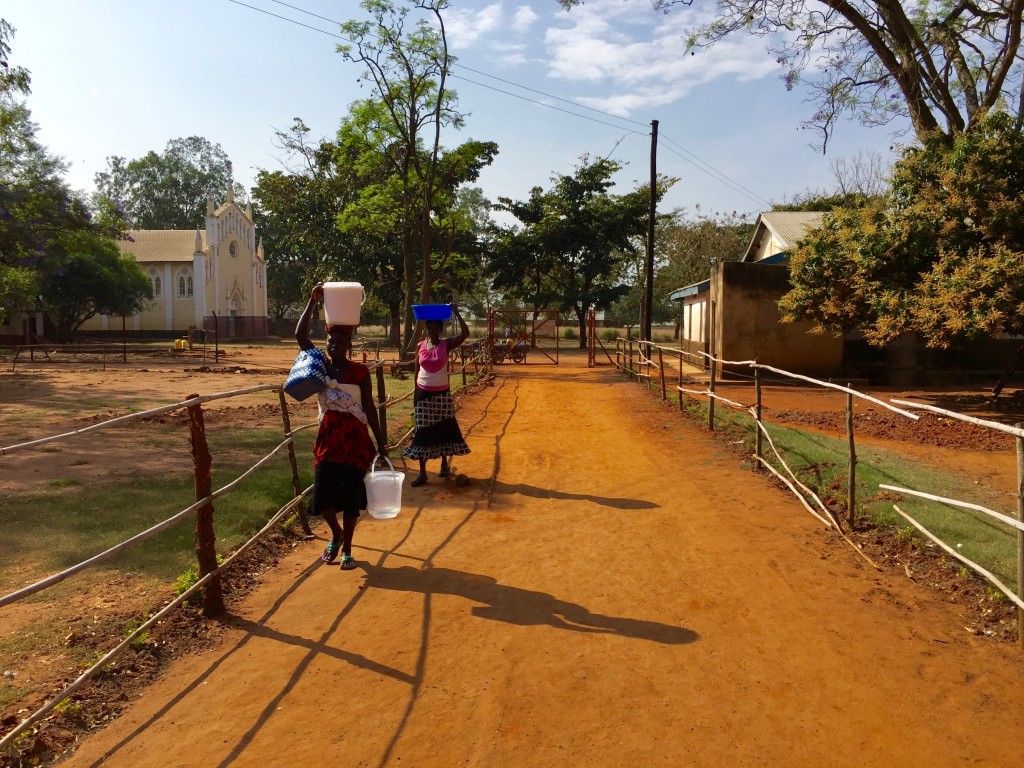 These two mothers are brining in the grain and water to make food for their children.