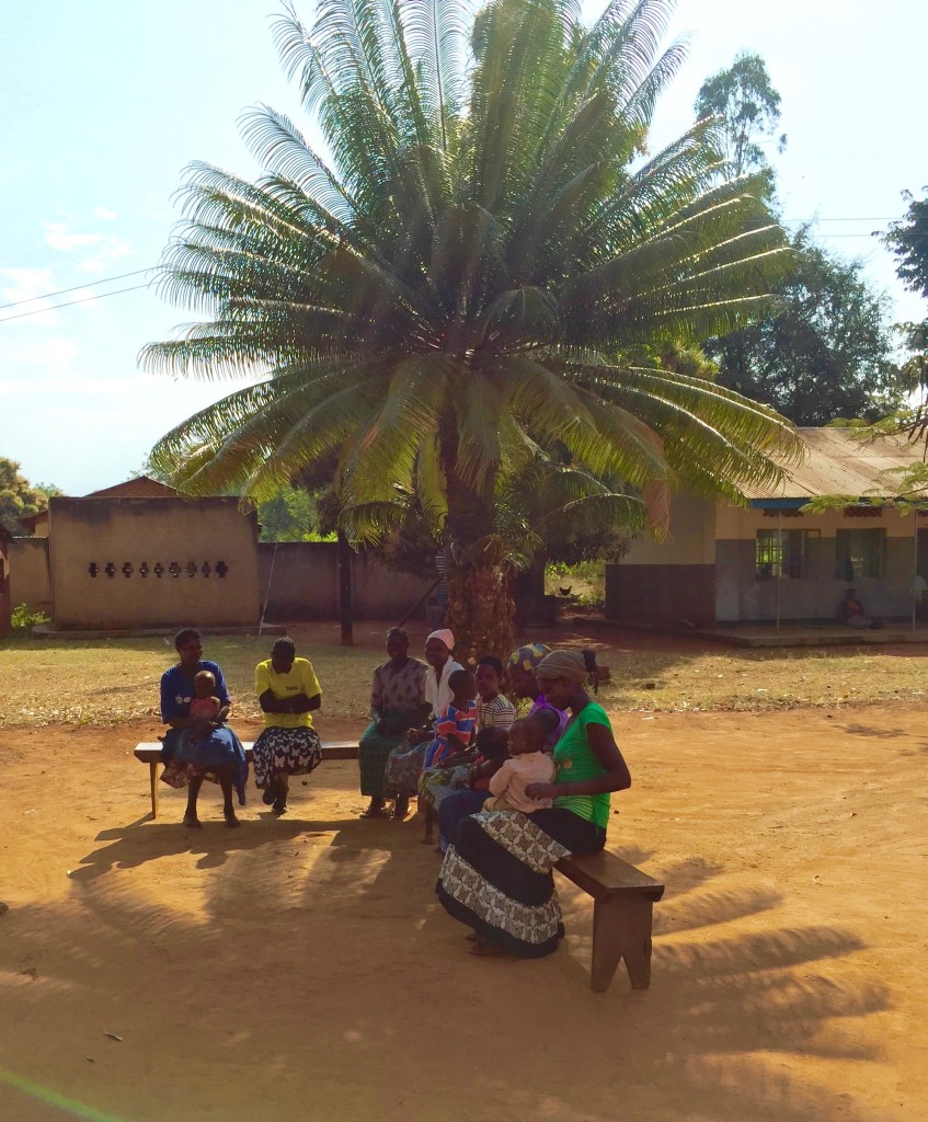 The mothers staying out of the hot sun and holding the children that are able to leave the bed.