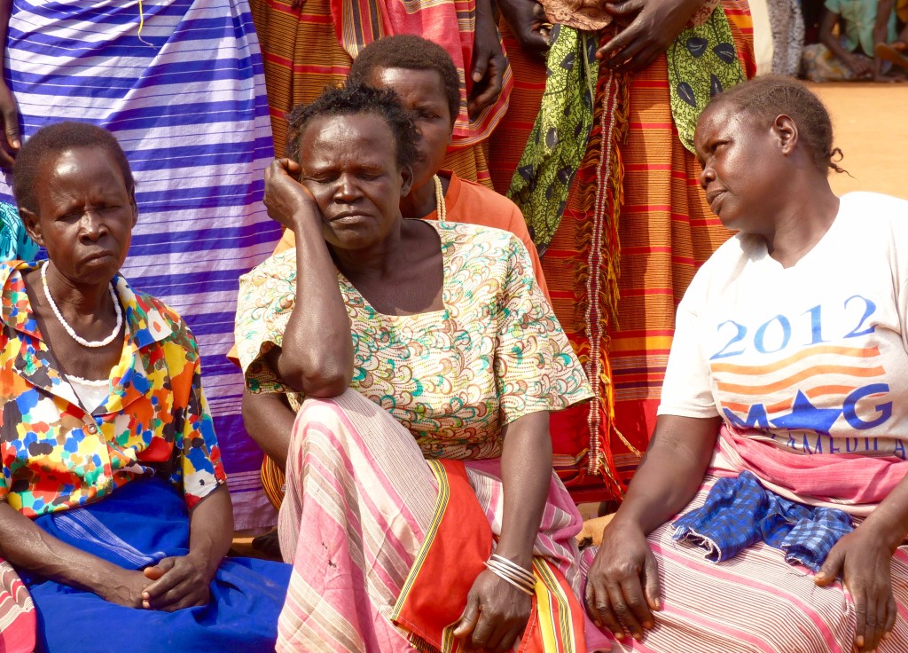 The women lament during a funeral song.